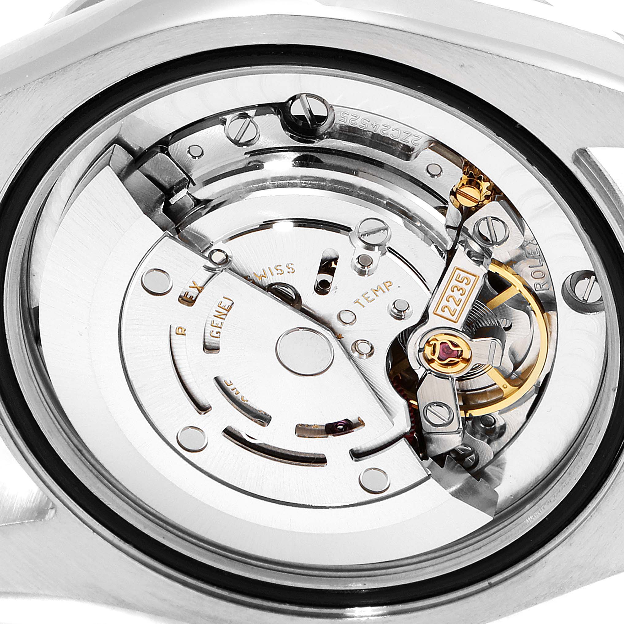 The image shows a close-up of the movement mechanism inside a Mid-Size Rolex watch, viewed from the back.