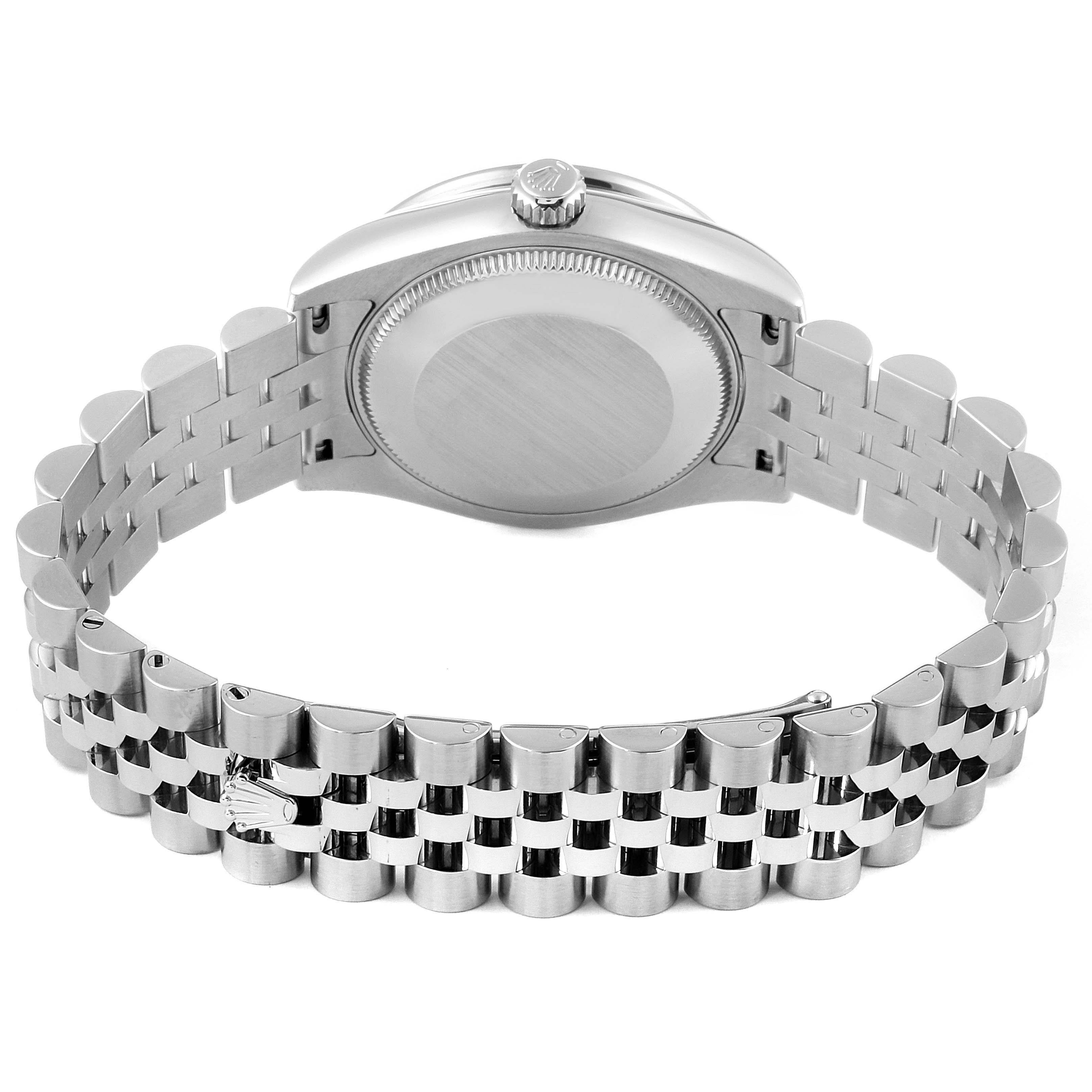 This image shows the back and part of the metal bracelet of a mid-size Rolex watch.