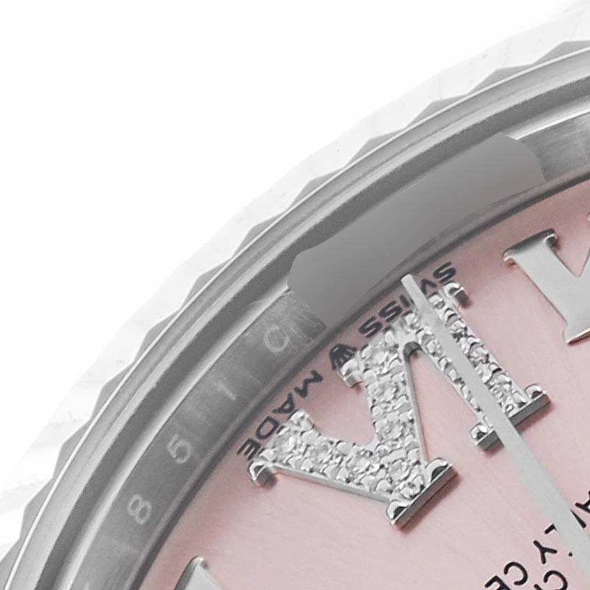 The image shows the top-right section of a Rolex Mid-Size 278274 Women's Stainless Steel Pink Dial 278274 Women's Stainless Steel Pink Dial watch, featuring the bezel, part of pink dial, and hour marker.
