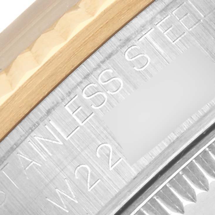 The image shows a close-up of the side and edge of the bezel on a Rolex Mid-Size 68273 Women's Steel and Gold (two tone) Red Dial 68273 Women's Steel and Gold (two tone) Red Dial watch, highlighting "STAINLESS STEEL."