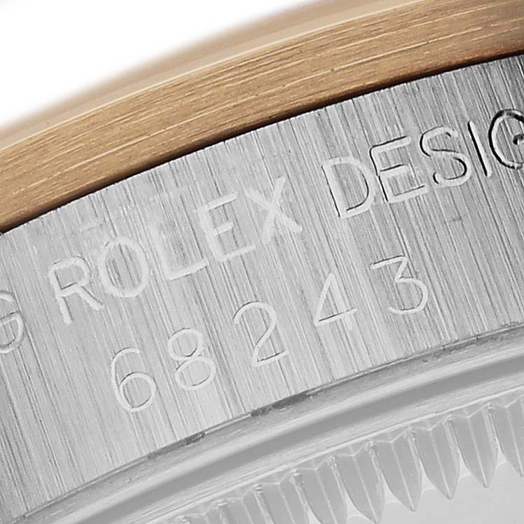 The image shows the engraved side detail of a Rolex Mid-Size 68243 Women's Steel and Gold (two tone) Grey Dial 68243 Women's Steel and Gold (two tone) Grey Dial watch case.