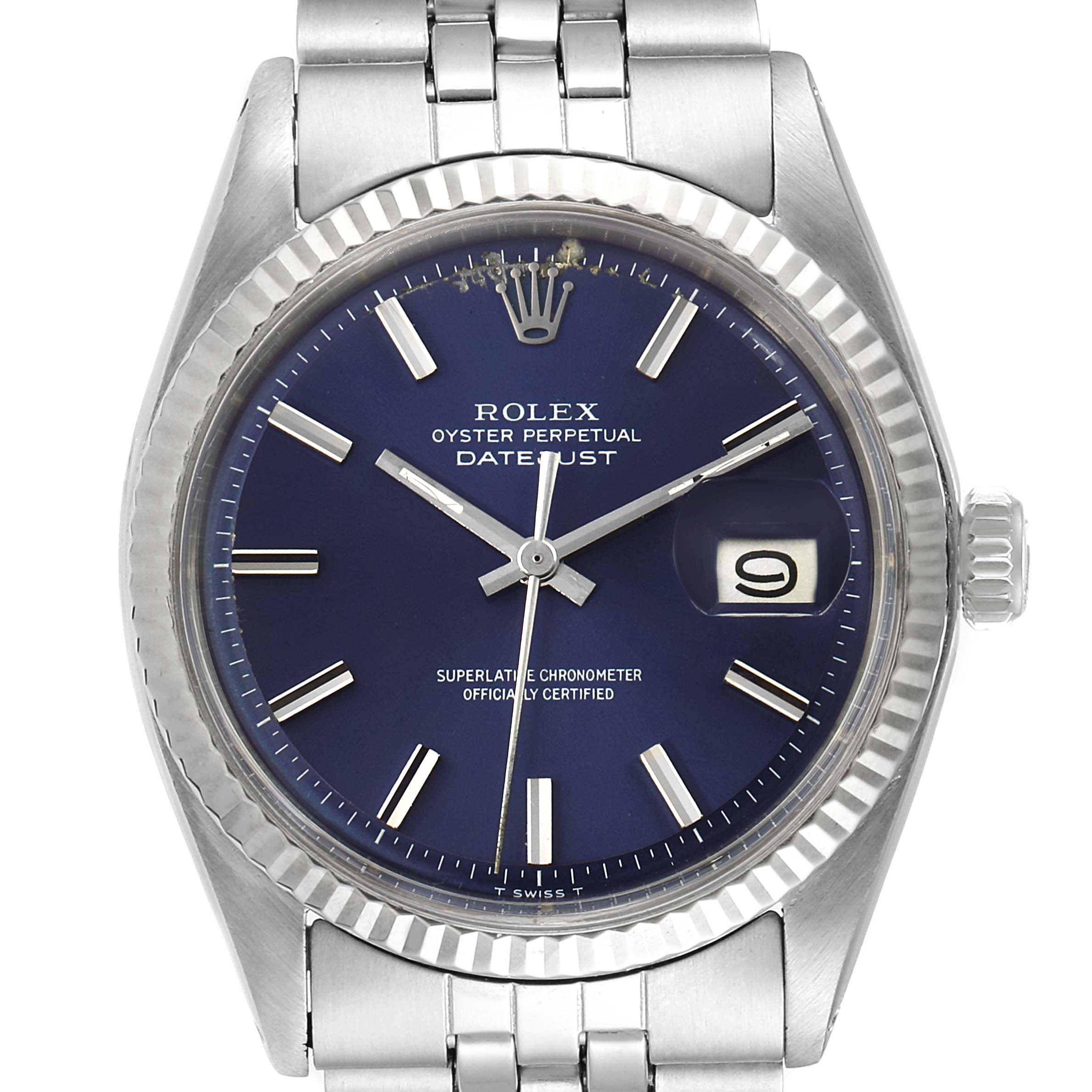 The image shows a front view of the Rolex Vintage Collection 1601 Men's Stainless Steel Blue Dial 1601 Men's Stainless Steel Blue Dial Datejust model, highlighting its blue dial, fluted bezel, and part of the bracelet.