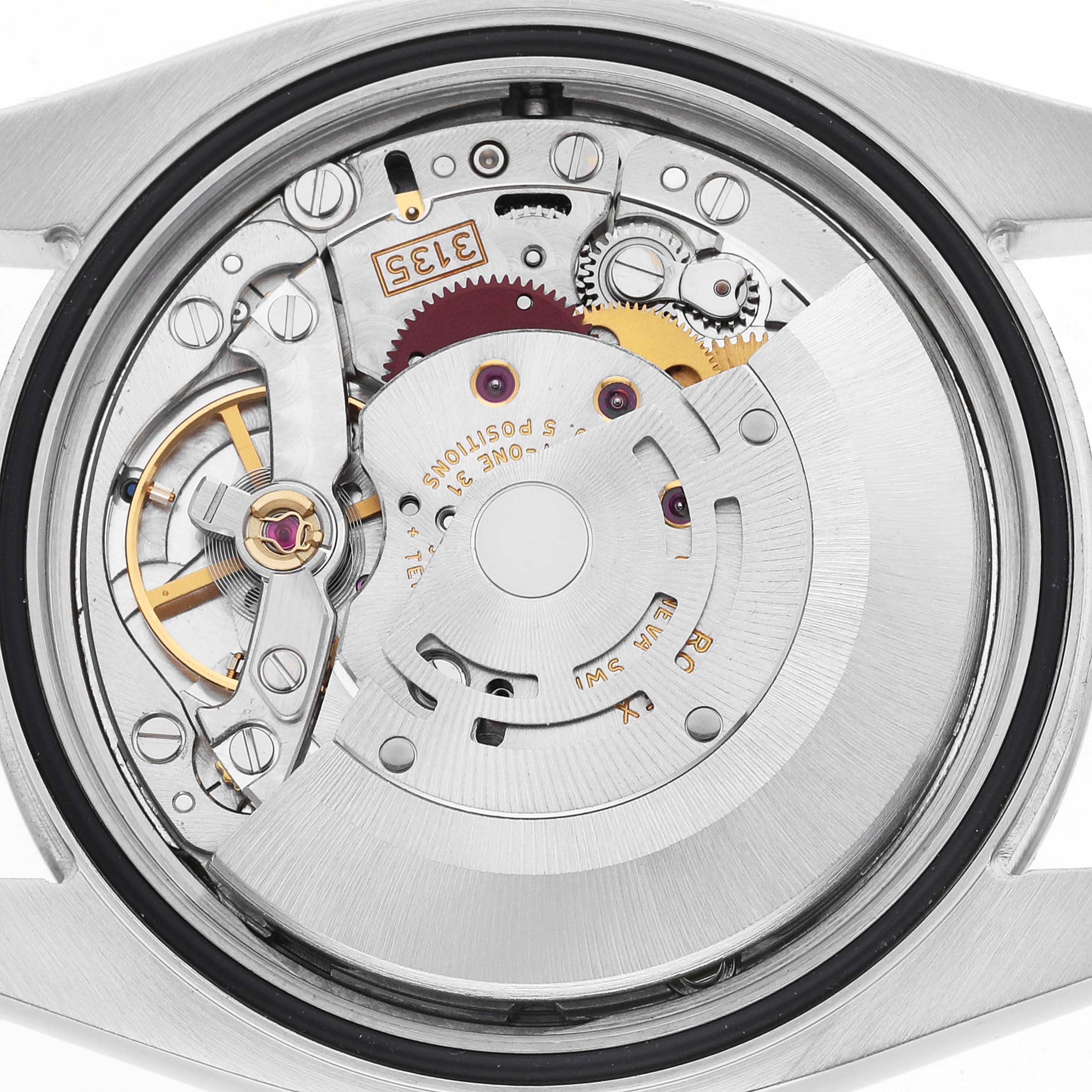 The image shows the movement of a Rolex Datejust 116234 Men's Stainless Steel Silver Dial, viewed from the back, highlighting gears and components.