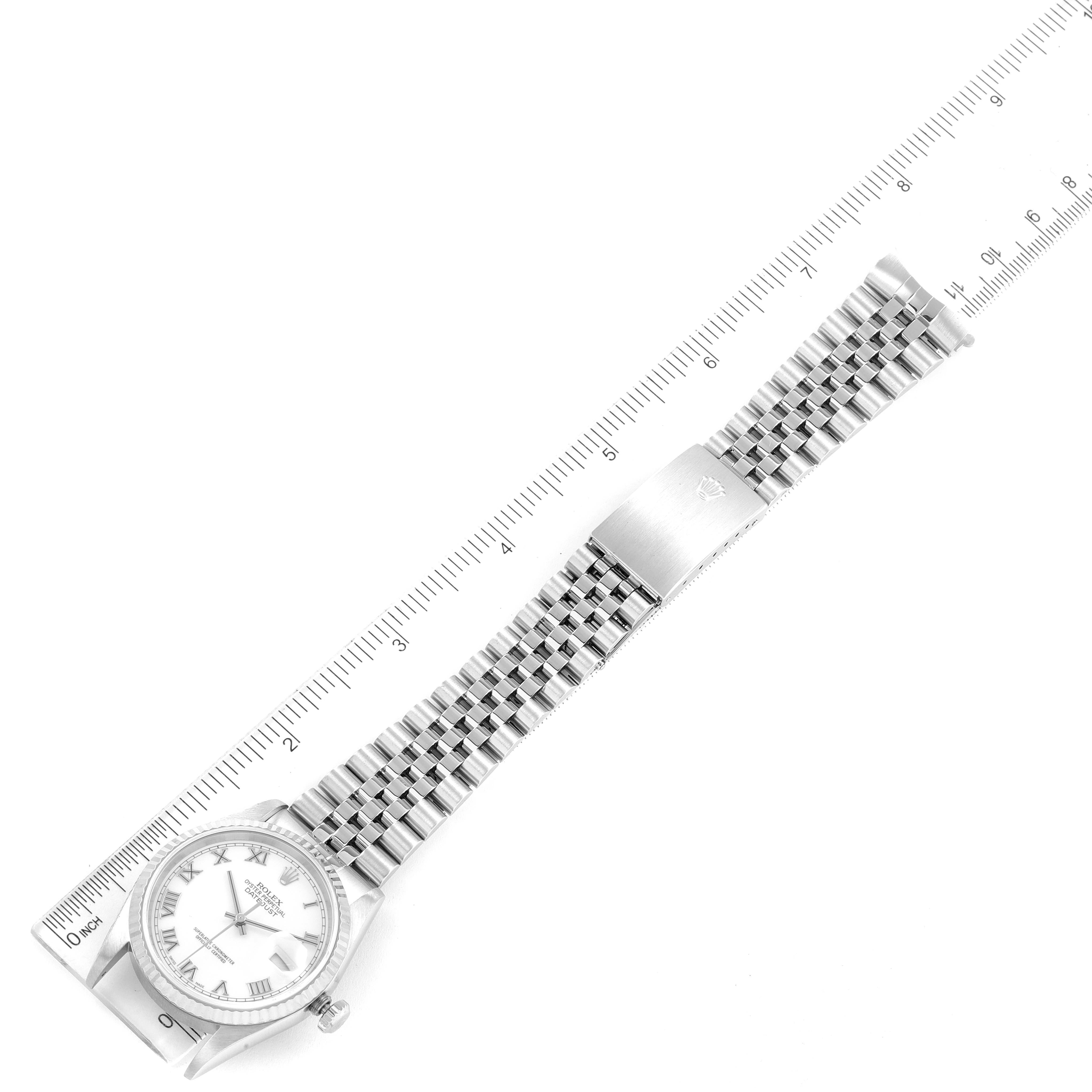 The image shows the front view of a Rolex Datejust 16234 Men's Stainless Steel White Dial 16234 Men's Stainless Steel White Dial watch, including the face, bezel, and full-length bracelet, placed next to a ruler.
