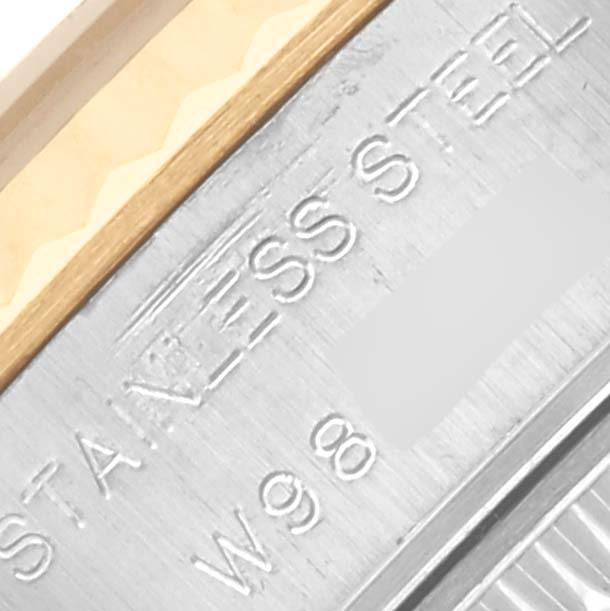 The image shows an angled close-up of the Rolex Datejust 69173 Women's Steel and Gold (two tone) Champagne Dial 69173 Women's Steel and Gold (two tone) Champagne Dial watch's bezel and case, highlighting "Stainless Steel" engraving.