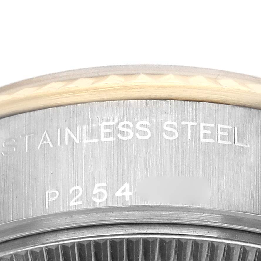 The image shows a close-up of the side engravings on the stainless steel casing of a Rolex Datejust 79173 Women's Steel and Gold (two tone) Champagne Dial 79173 Women's Steel and Gold (two tone) Champagne Dial.