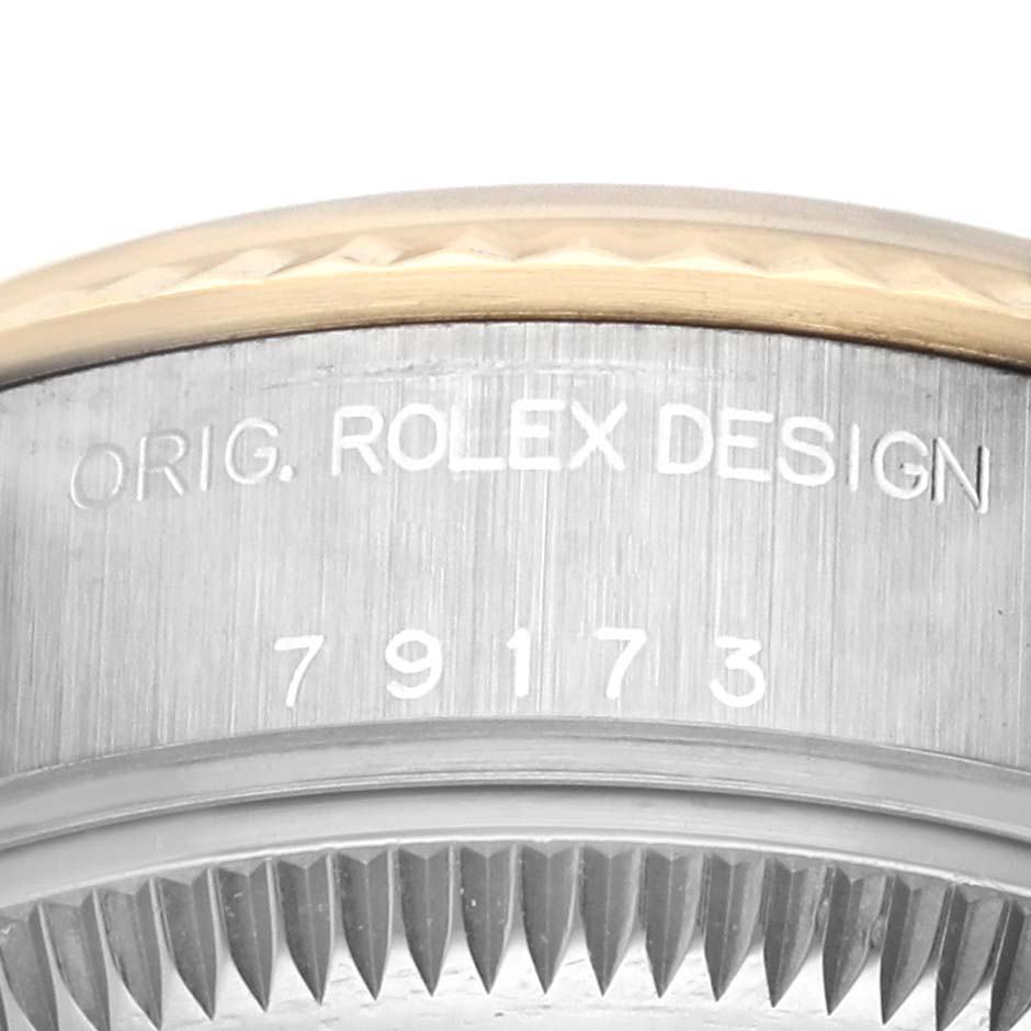 This image shows the side view of a Rolex Datejust 79173 Women's Steel and Gold (two tone) Champagne Dial 79173 Women's Steel and Gold (two tone) Champagne Dial watch case, highlighting the model number and part of the bezel.