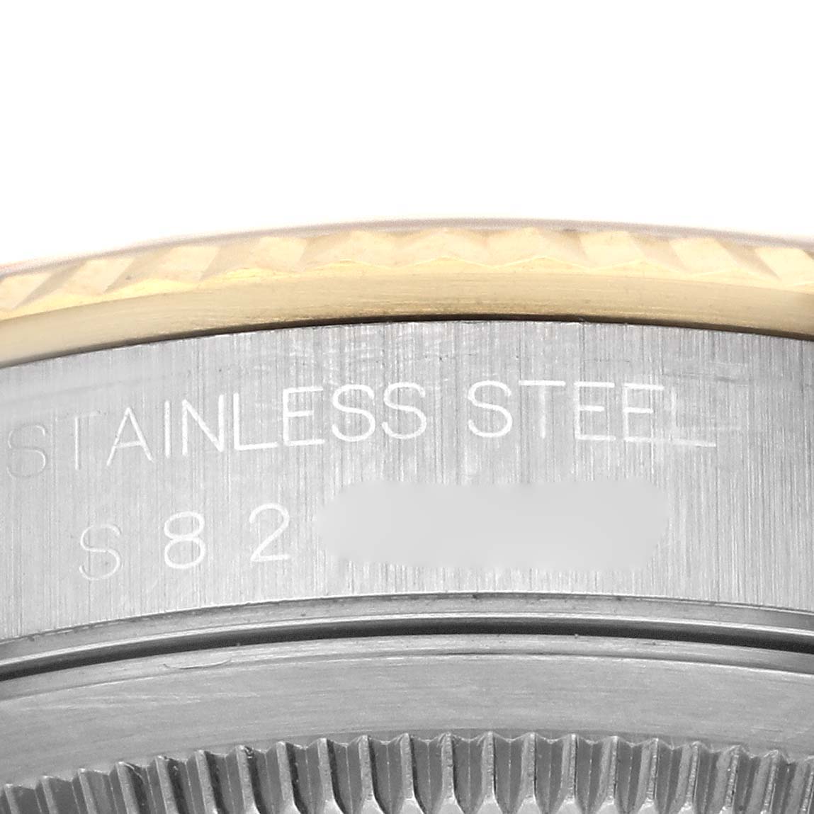 The image shows a close-up of the case back and edge of the bezel of a Rolex Datejust 16233 Men's Steel and Gold (two tone) Champagne Dial 16233 Men's Steel and Gold (two tone) Champagne Dial, highlighting "stainless steel" engraving.