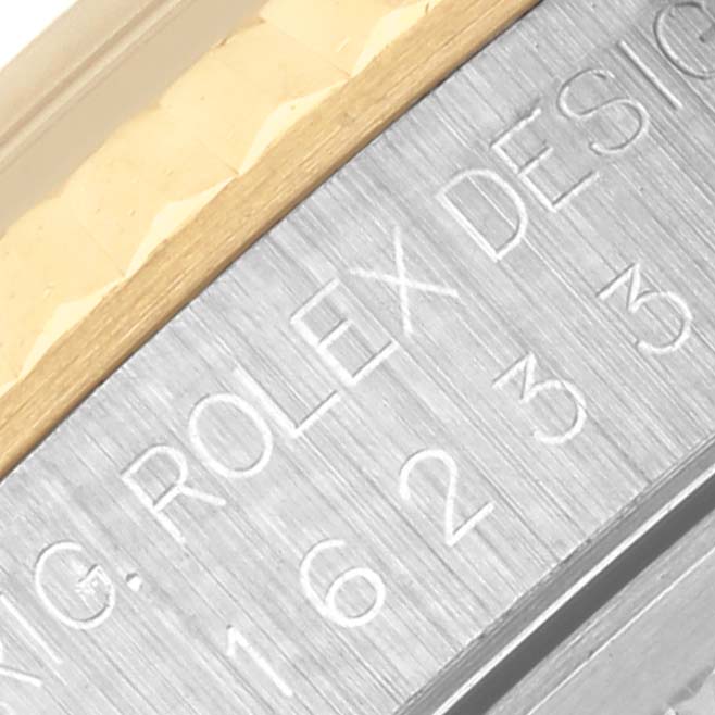 The image shows a close-up of the side engraving on a Rolex Datejust 16233 Men's Steel and Gold (two tone) Champagne Dial 16233 Men's Steel and Gold (two tone) Champagne Dial watch case.