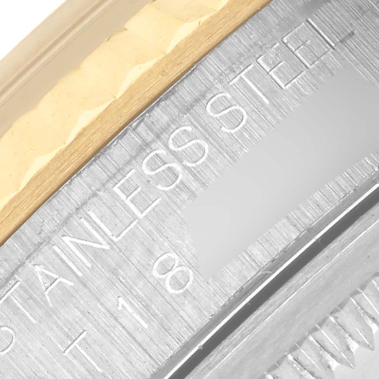 The image shows a close-up of the bezel and engravings on a Rolex Datejust 16233 Men's Steel and Gold (two tone) Champagne Dial 16233 Men's Steel and Gold (two tone) Champagne Dial watch, highlighting the stainless steel and gold components.