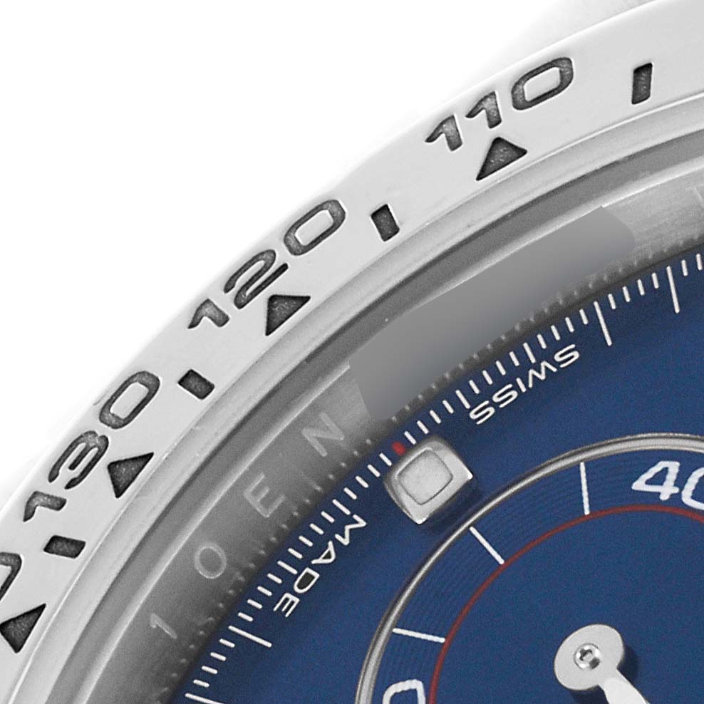The image shows a close-up of the bezel and part of the dial on a Rolex Daytona 116509 Men's White Gold Blue Dial 116509 Men's White Gold Blue Dial watch.