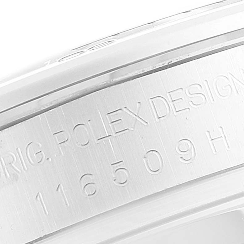 The image shows an angled view of the Rolex Daytona 116509 Men's White Gold Blue Dial 116509 Men's White Gold Blue Dial model's case side with engraved text.