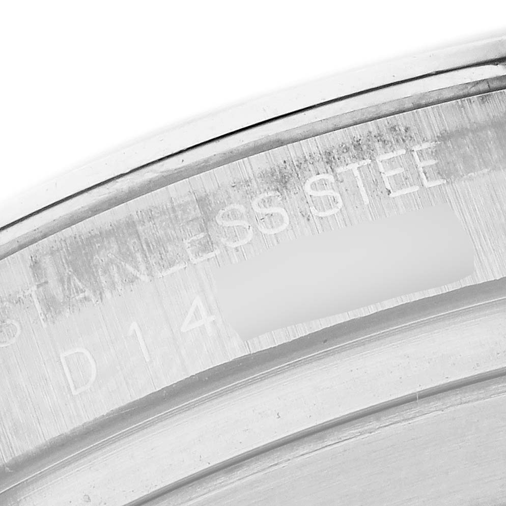 The image shows a close-up of the edge engraving on the case back of a Rolex Daytona 116520 Men's Stainless Steel White Dial 116520 Men's Stainless Steel White Dial watch, highlighting the stainless steel marking.