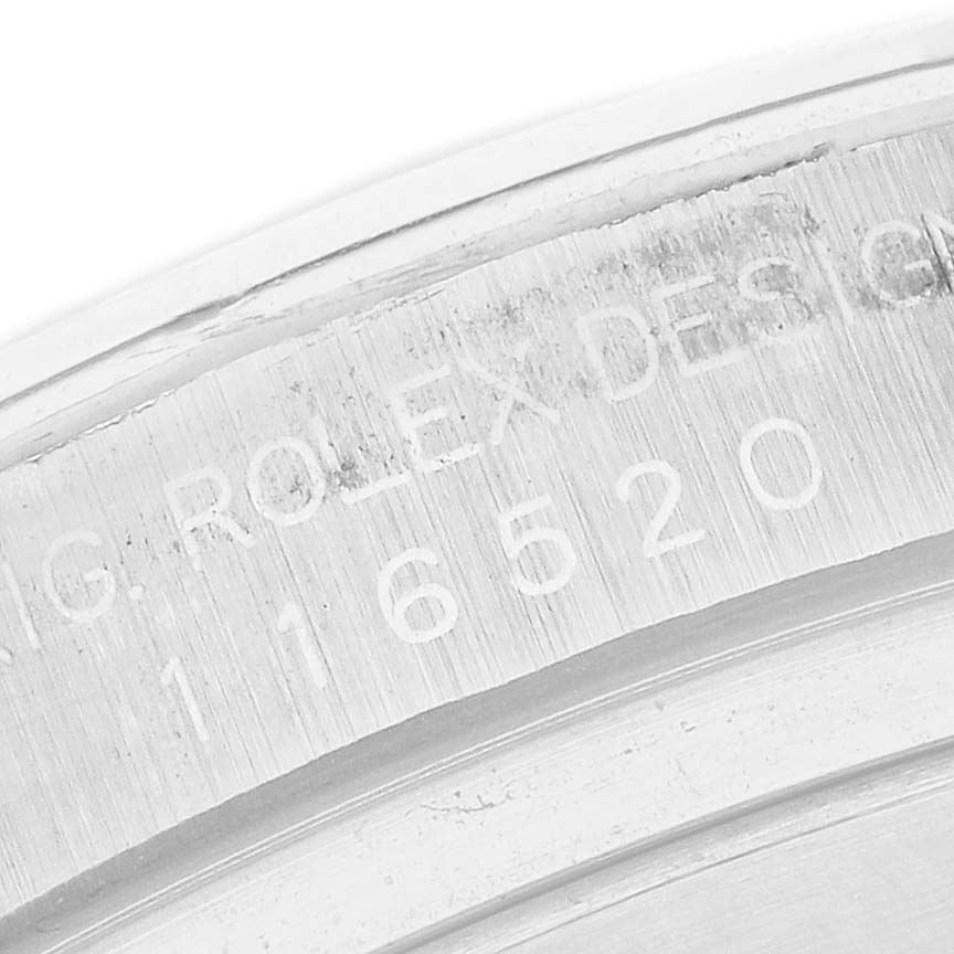 The image shows an engraved side view of the case with serial/model number of the Rolex Daytona 116520 Men's Stainless Steel White Dial 116520 Men's Stainless Steel White Dial.