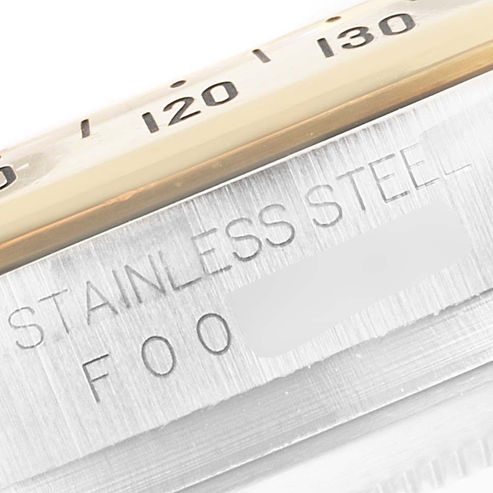 The image shows a close-up of the stainless steel case and bezel of the Rolex Daytona 116523 Men's Steel and Gold (two tone) Mother of Pearl Dial 116523 Men's Steel and Gold (two tone) Mother of Pearl Dial watch, highlighting the engraved text.