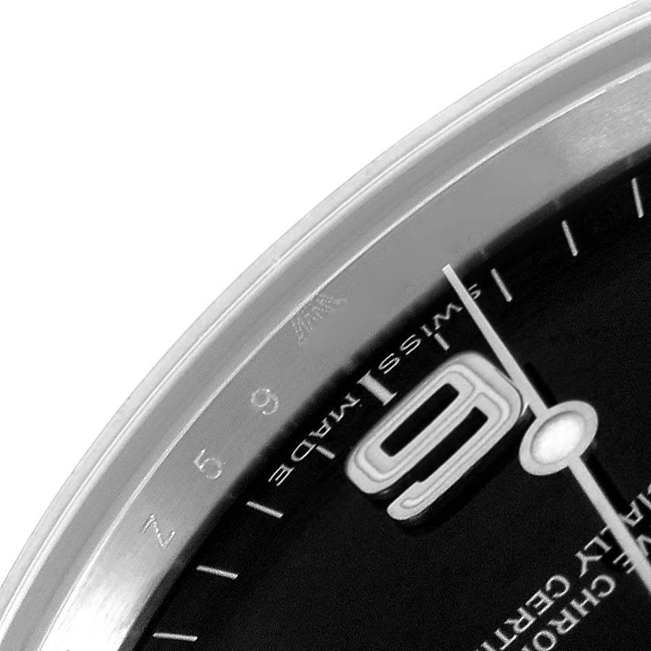 The image shows a close-up of the dial and bezel corner of a Rolex Explorer 114270 Men
s Stainless Steel Black Dial 114270 Men
s Stainless Steel Black Dial watch, highlighting the "9" marker and "Swiss Made" text.