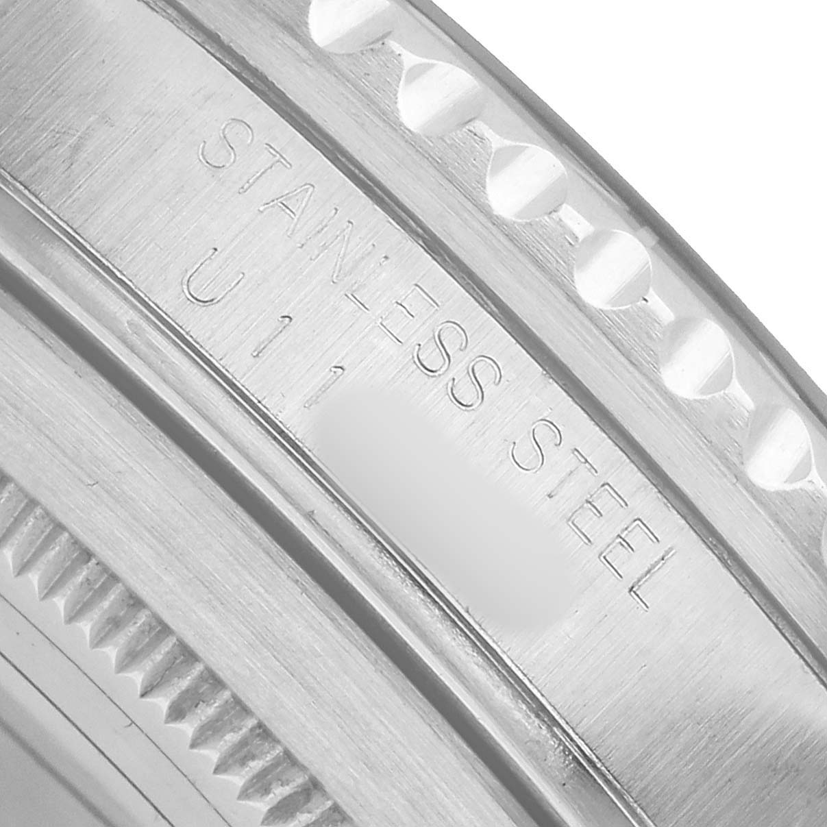 Angled close-up of the Rolex GMT-Master 16710 Men's Stainless Steel Black Dial bezel, showing the stainless steel engraving and teeth detail.