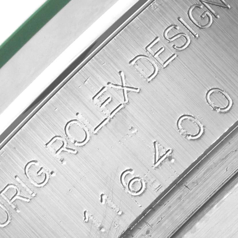 The image shows a close-up of the Milgauss Rolex model's engraved design number on the case.