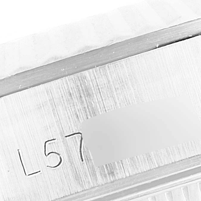 This image shows a close-up of the side of a Rolex Oyster Perpetual 67194 Women's Stainless Steel Silver Dial 67194 Women's Stainless Steel Silver Dial watch, highlighting its engraved serial number.