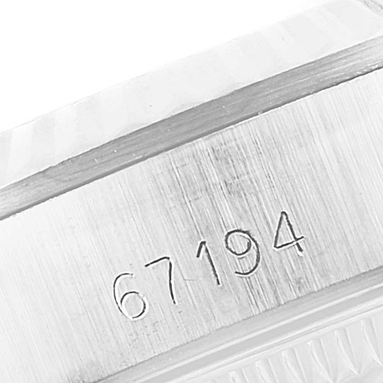 This image shows a close-up of the case with the serial number engraving on a Rolex Oyster Perpetual 67194 Women's Stainless Steel Silver Dial 67194 Women's Stainless Steel Silver Dial model watch.