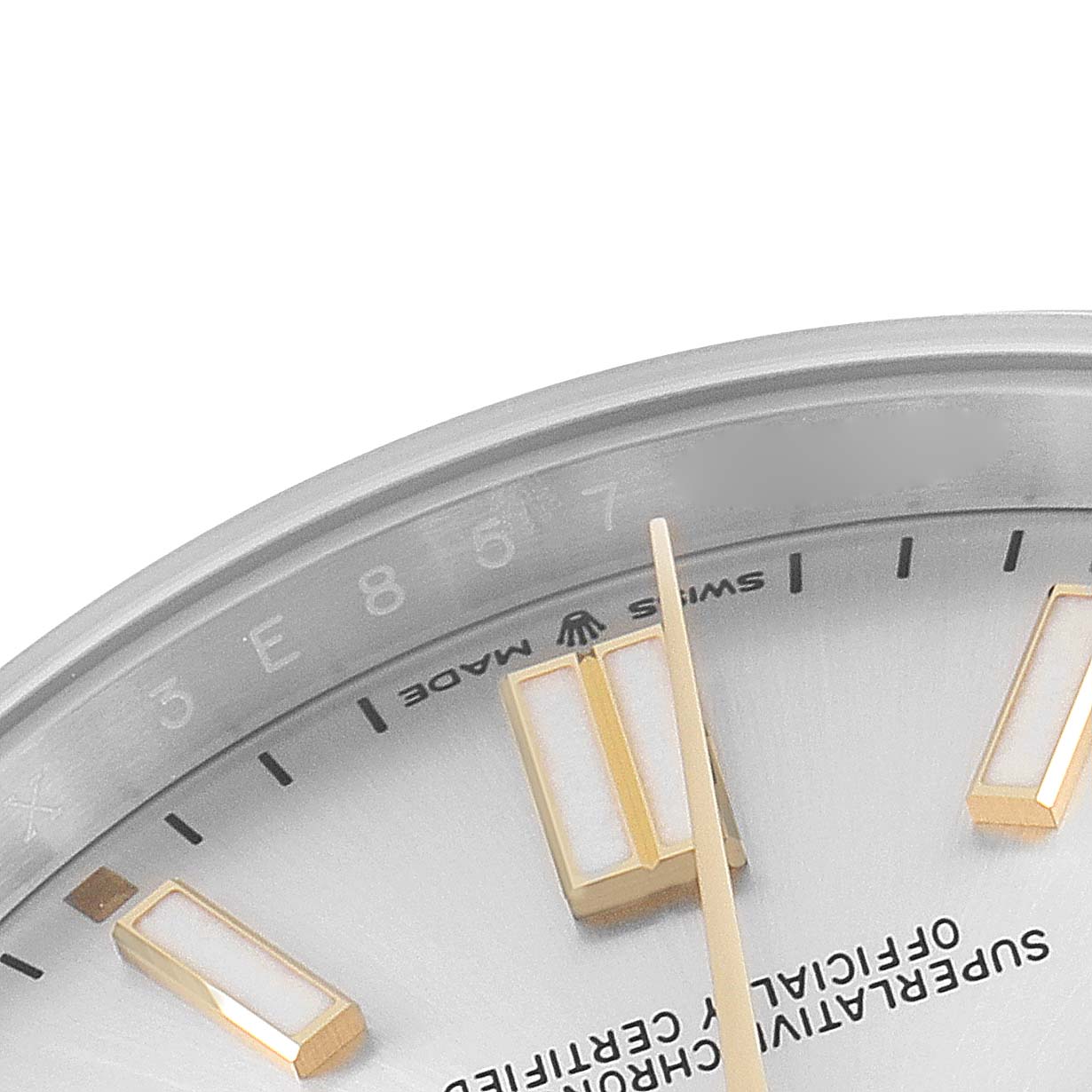 This image shows a close-up of the dial and markers of a Rolex Oyster Perpetual 124300 Men's Stainless Steel Silver Dial 124300 Men's Stainless Steel Silver Dial watch, focusing on the numerals and part of the hands.