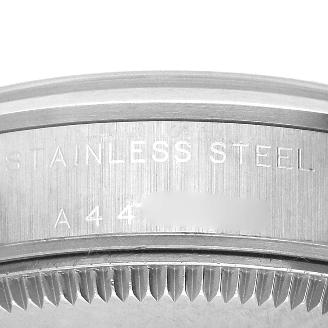 The image shows a close-up of the stainless steel case side of a Rolex Mid-Size 77080 Women's Stainless Steel Pink Dial 77080 Women's Stainless Steel Pink Dial model, featuring part of the engraving.