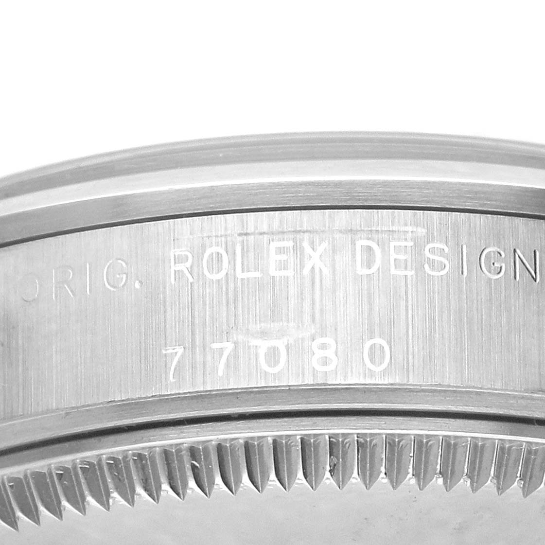 The image shows a close-up of the side engraving on a Rolex Mid-Size 77080 Women's Stainless Steel Pink Dial 77080 Women's Stainless Steel Pink Dial watch bezel with the model number 77080.