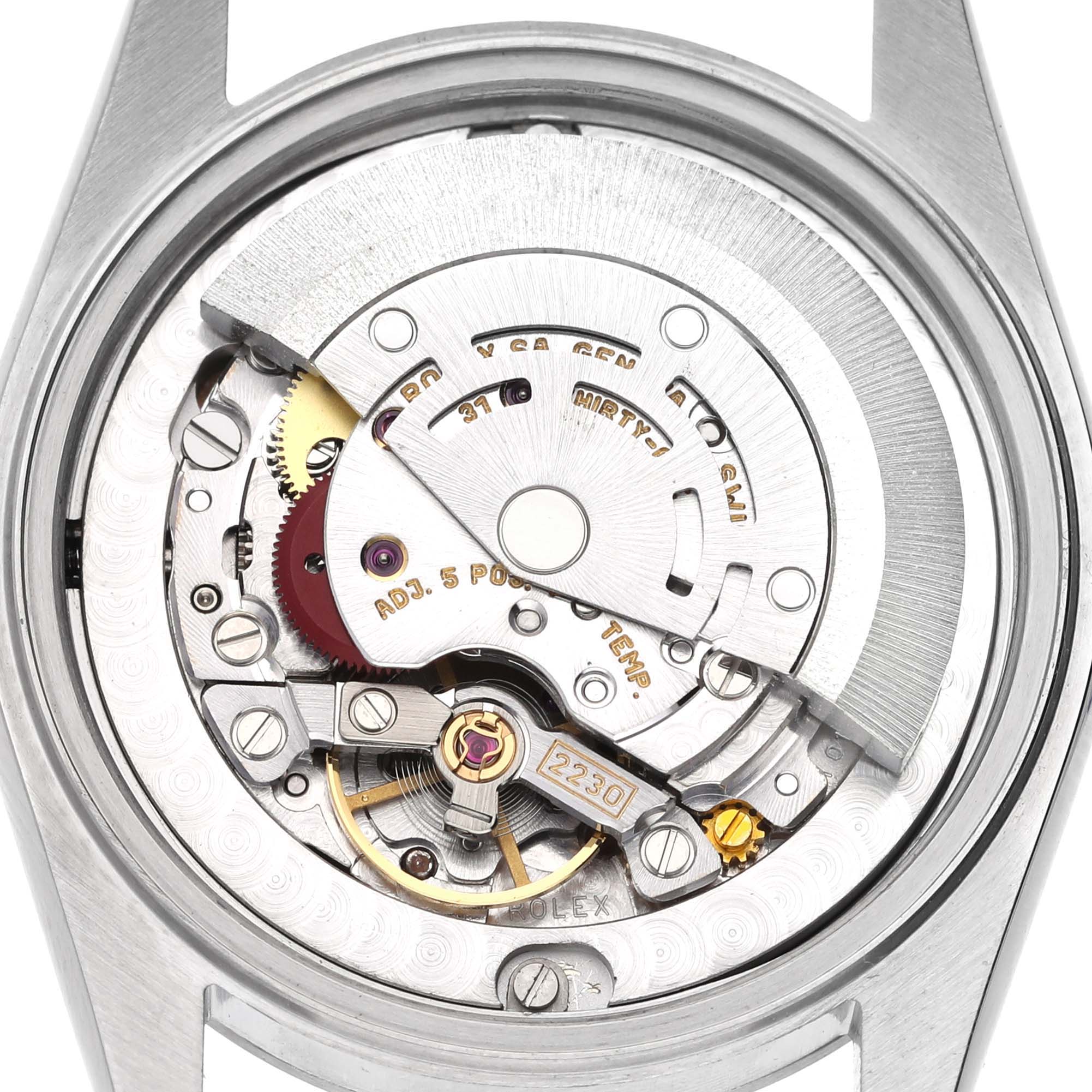 The image shows the intricate movement of a Rolex Mid-Size 77080 Women's Stainless Steel Silver Dial 77080 Women's Stainless Steel Silver Dial watch from the back, highlighting gears and the rotor.