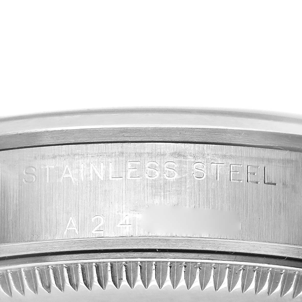The image shows the side of a stainless steel Rolex Mid-Size 77080 Women's Stainless Steel Silver Dial 77080 Women's Stainless Steel Silver Dial watch case with engraved details.