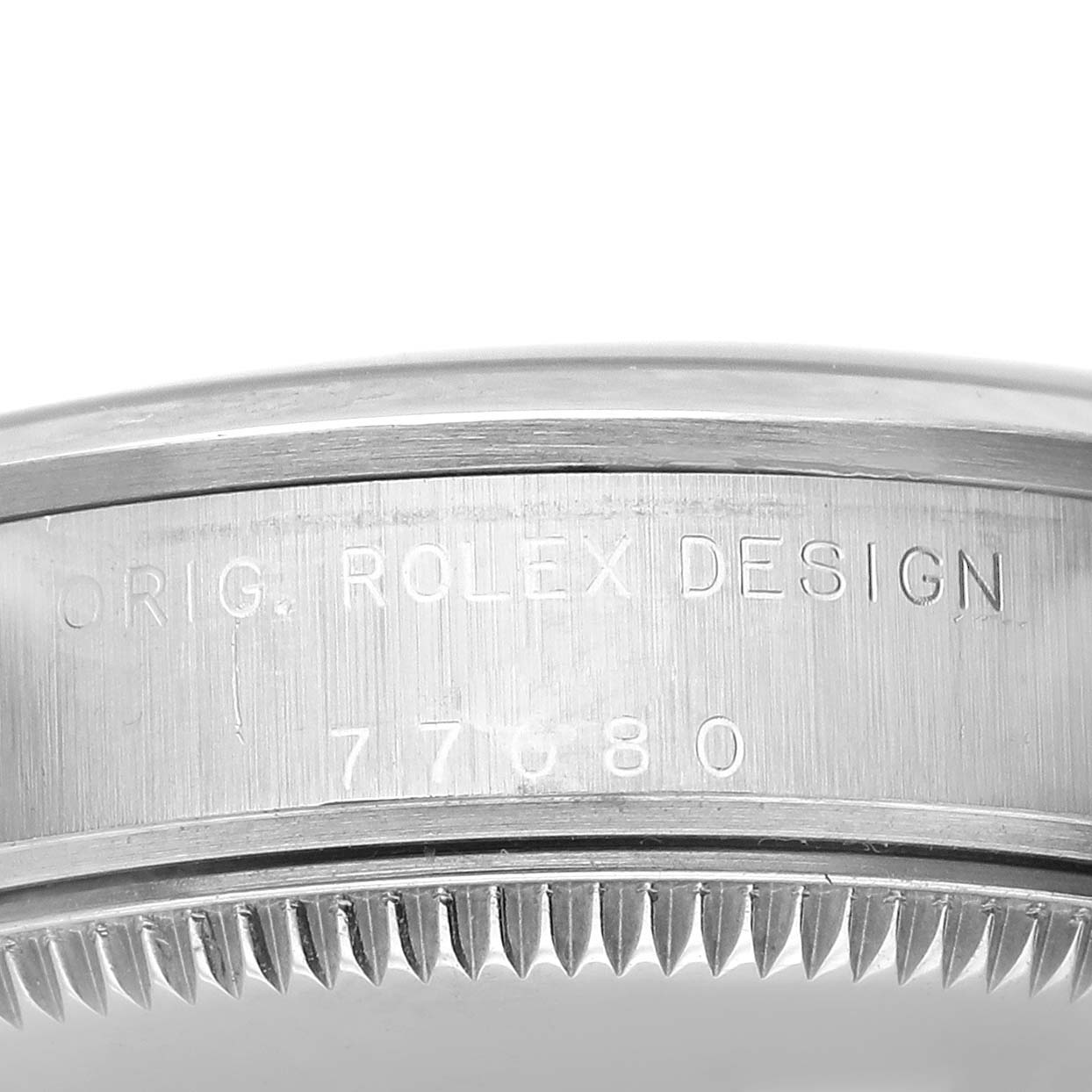 The image shows a close-up of the side engraving on the bezel of a mid-size Rolex watch, highlighting the model number.