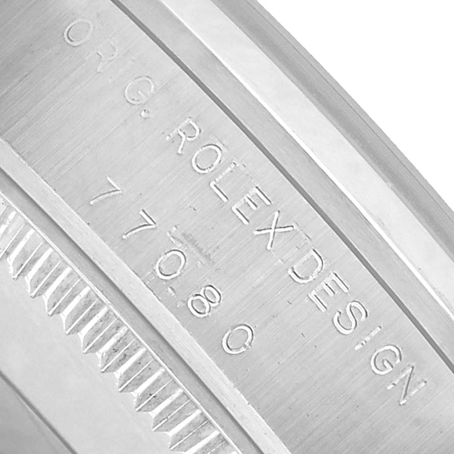 The image shows a close-up of the case side of a Rolex Mid-Size 77080 Women's Stainless Steel Silver Dial watch, highlighting the engraved model number.