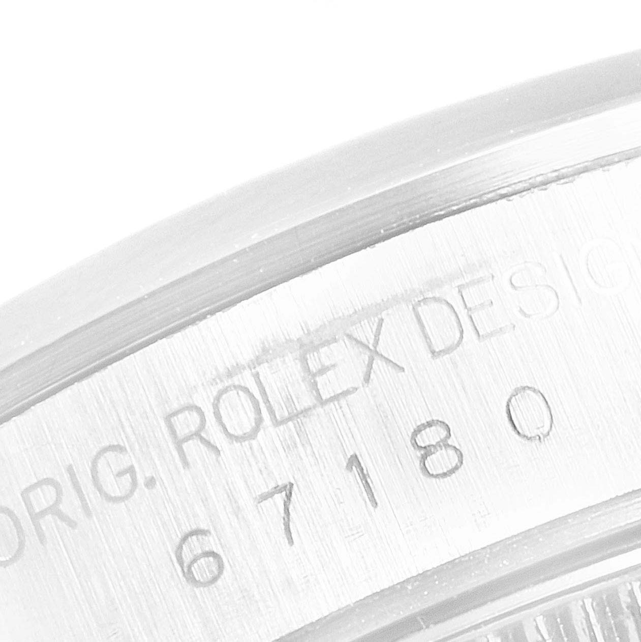 The image shows a close-up of the engraving on the case side of a Rolex Oyster Perpetual 67180 Women's Stainless Steel Pink Dial 67180 Women's Stainless Steel Pink Dial watch.