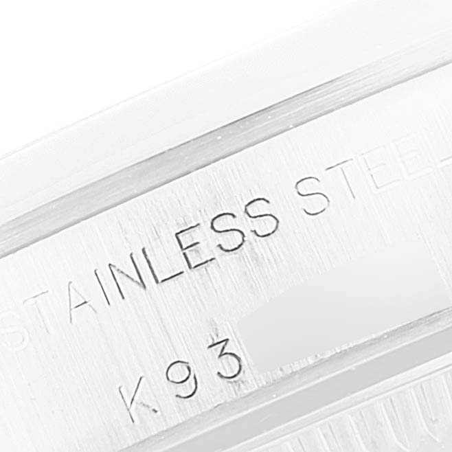 This image shows a close-up of the Rolex Oyster Perpetual 76080 Women's Stainless Steel White Dial 76080 Women's Stainless Steel White Dial's stainless steel case with engraved text.