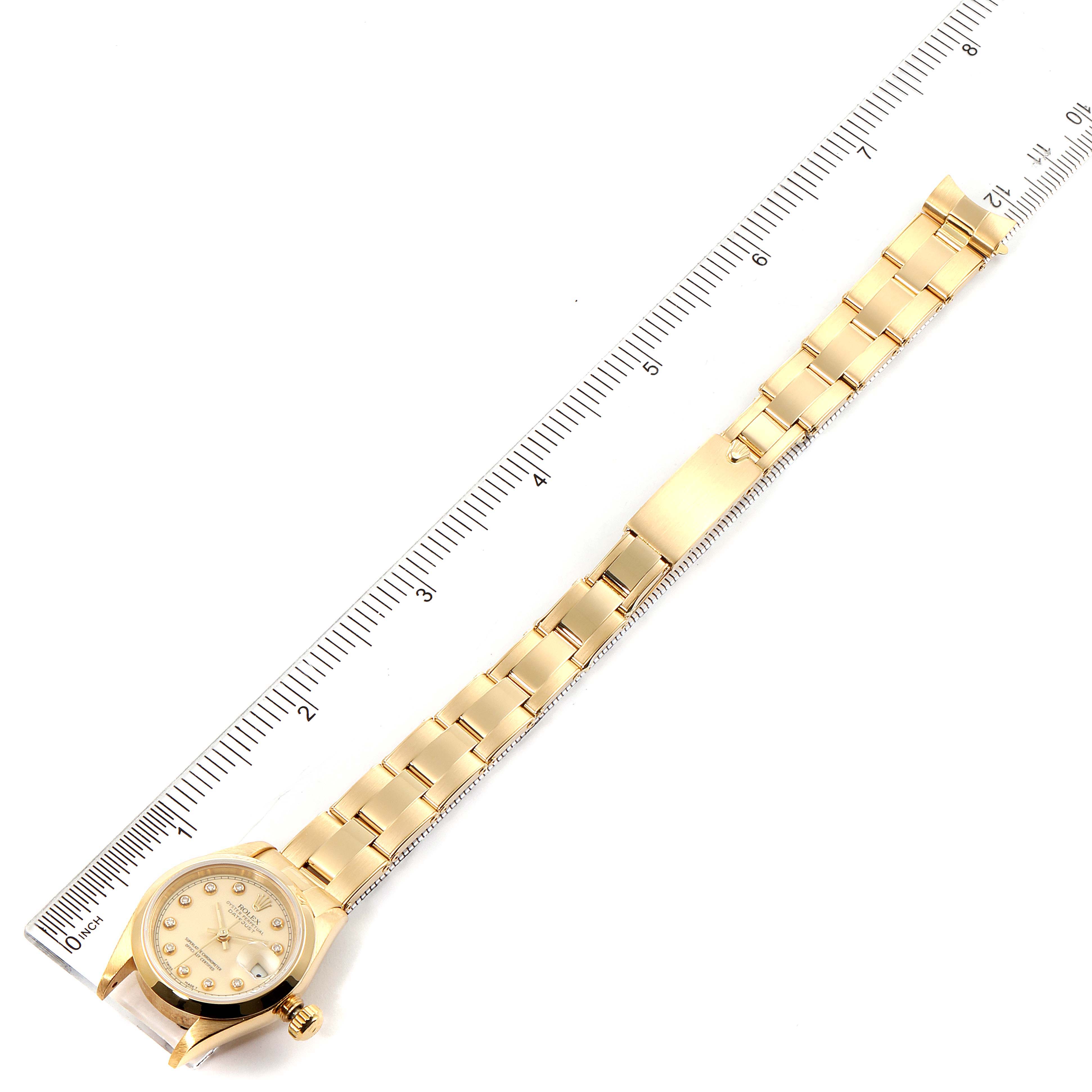 The image shows the Rolex President 69168 Women's Yellow Gold Beige Dial 69168 Women's Yellow Gold Beige Dial model watch laid flat with a ruler for scale, displaying its face and bracelet.