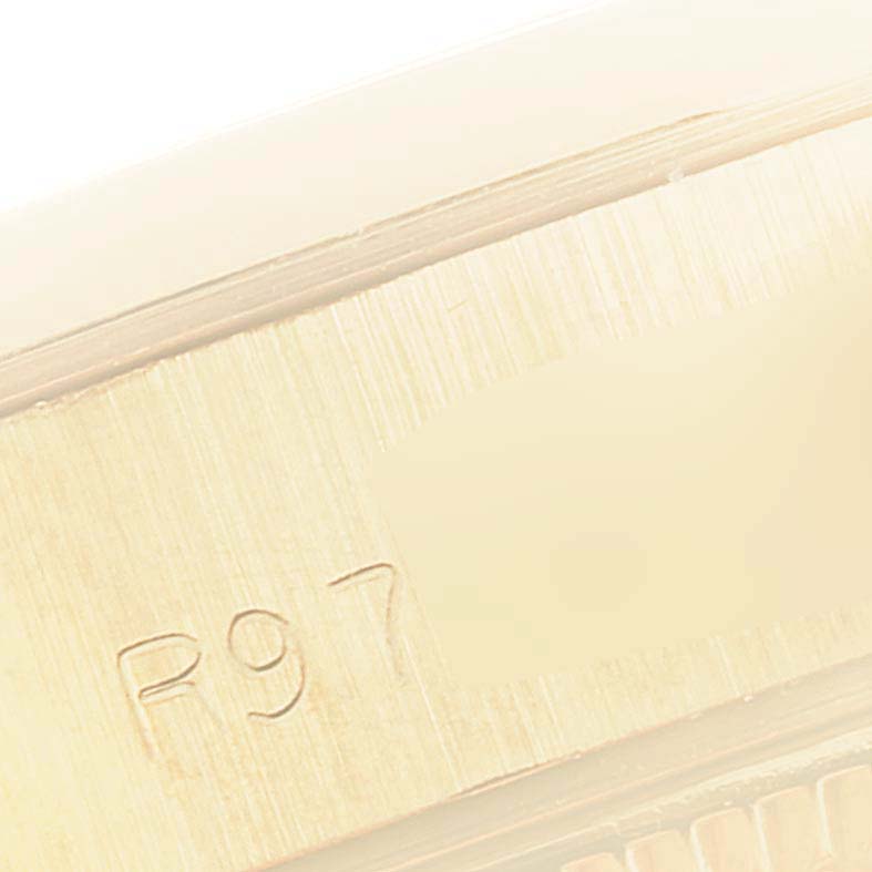 This is a close-up view of the engraving on the metal surface of a Rolex President 69168 Women's Yellow Gold Beige Dial 69168 Women's Yellow Gold Beige Dial model watch.