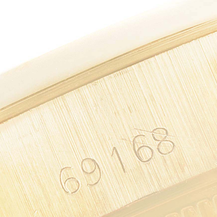 This close-up shows the engraved serial number on the case of a Rolex President 69168 Women's Yellow Gold Beige Dial 69168 Women's Yellow Gold Beige Dial model watch.