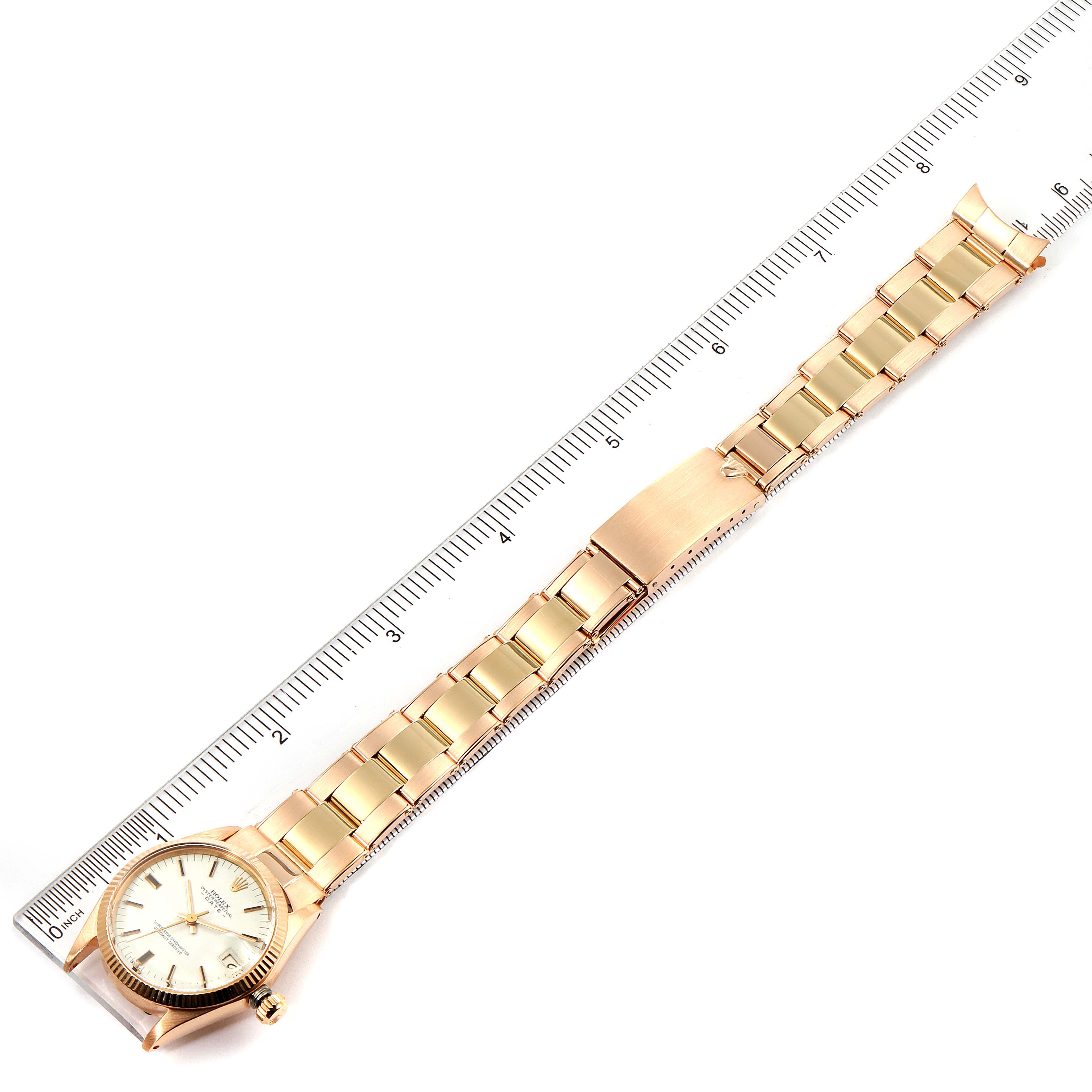 The image shows a Rolex President 6827 Women's Rose Gold White Dial 6827 Women's Rose Gold White Dial model watch laid flat with its bracelet aligned next to a ruler for measurement.