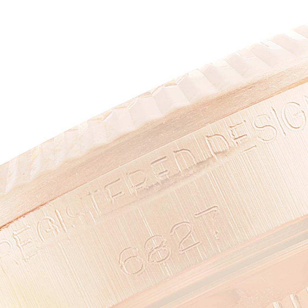 This close-up image shows the side edge and part of the bezel of a Rolex President 6827 Women's Rose Gold White Dial 6827 Women's Rose Gold White Dial model watch with some engraving visible.