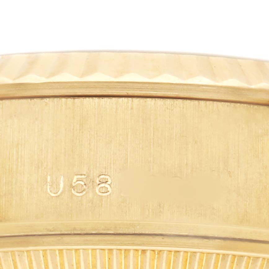 The image shows a close-up of the gold bezel and case side of a Rolex President 179178 Women's Yellow Gold Champagne Dial watch model, highlighting the engraved markings.