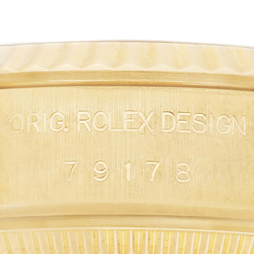 The image shows a close-up of the case side of a Rolex President 179178 Women's Yellow Gold Champagne Dial watch, highlighting the model number and branding engraving.