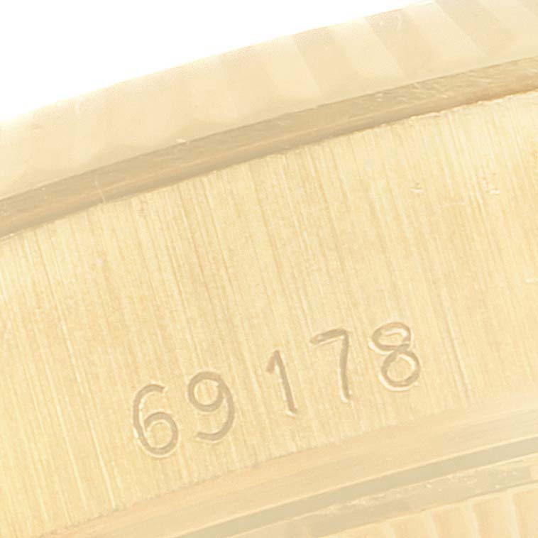 The image shows a close-up of the case side of a Rolex President 69178 Women
s Yellow Gold Champagne Dial 69178 Women
s Yellow Gold Champagne Dial model watch, highlighting the engraving of the reference number "69178."