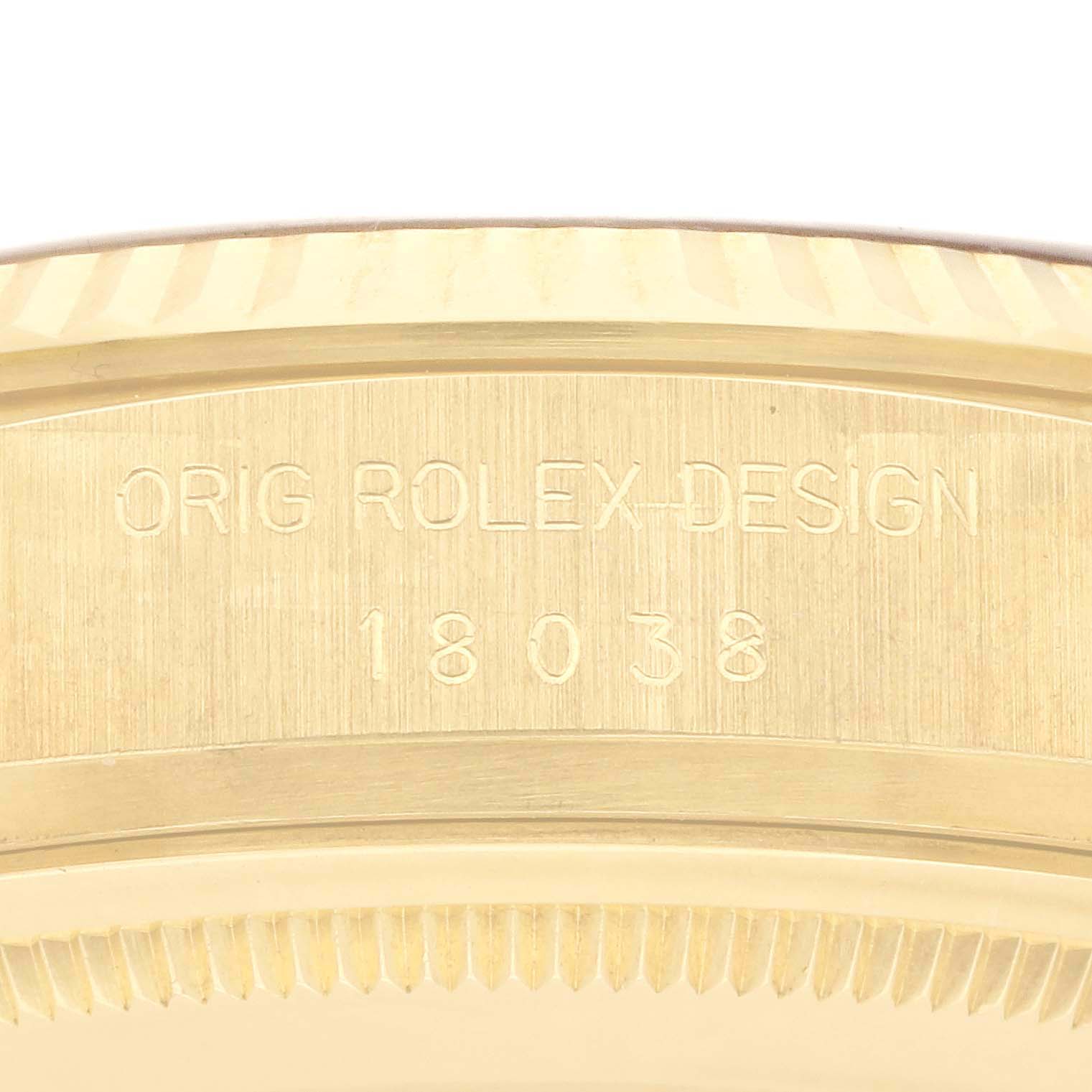 The image shows the side engraving on the case of a Rolex President 18038 Men
s Yellow Gold Champagne Dial 18038 Men
s Yellow Gold Champagne Dial model, displaying the design and model number "18038."