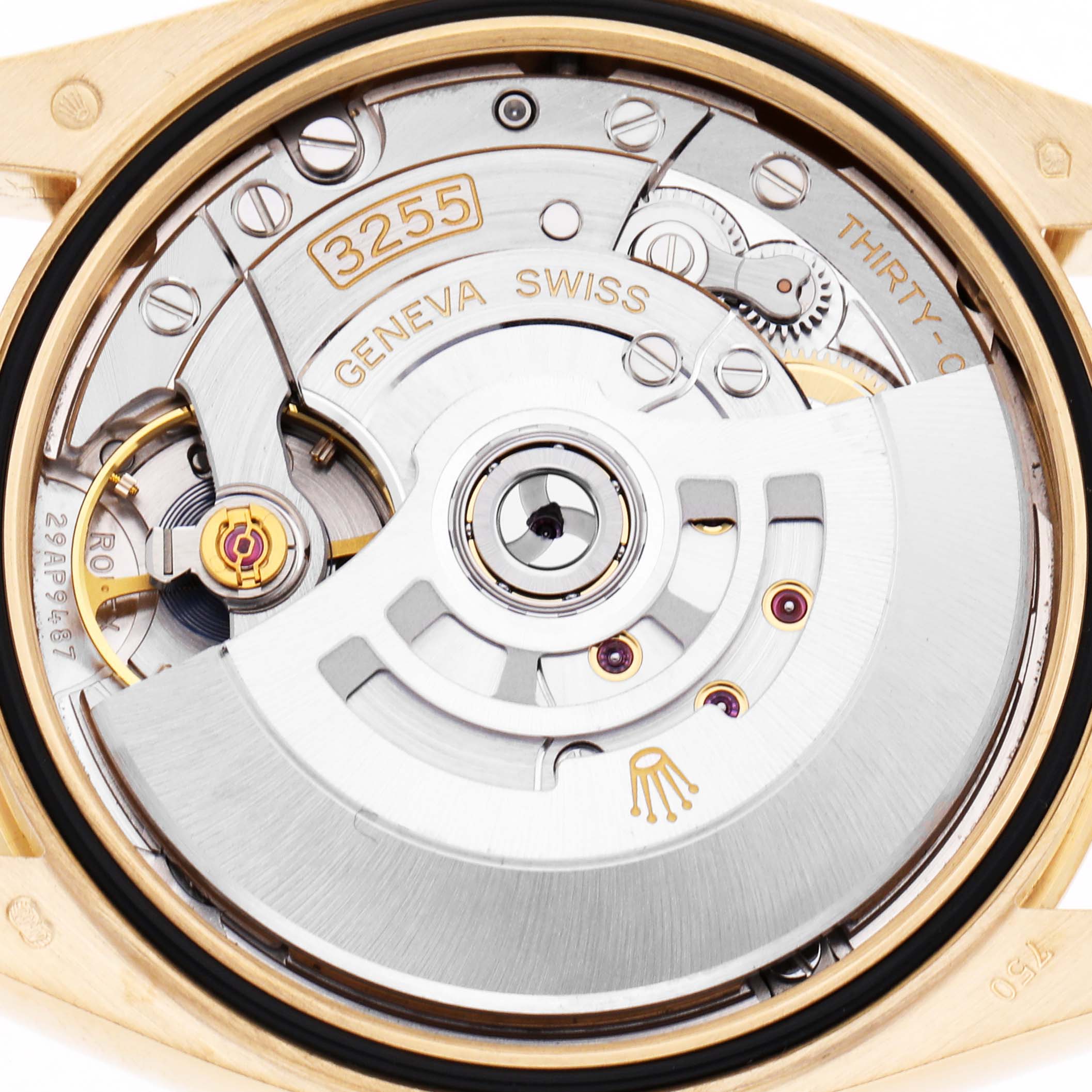 The image shows the back of a Rolex President 128238 Men's Yellow Gold Champagne Dial watch model, highlighting the intricate movement and rotor mechanics.