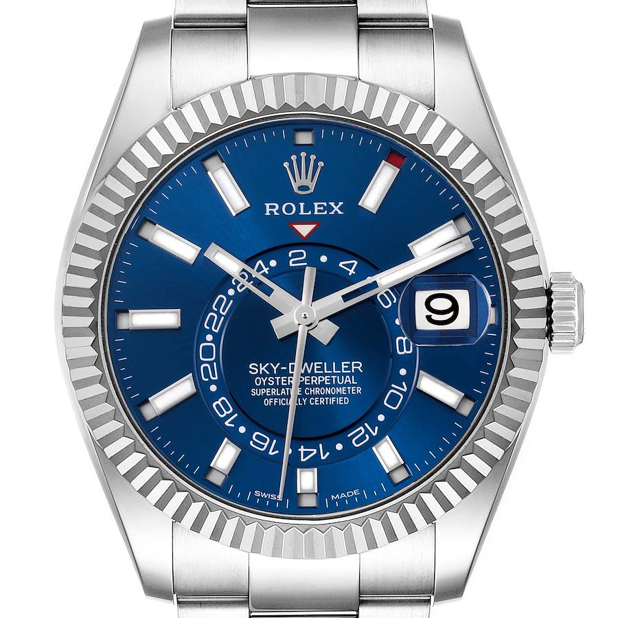 The Rolex Sky-Dweller is shown from a front angle, displaying the blue dial, hands, hour markers, and date window.