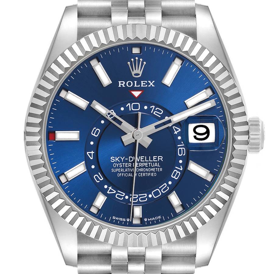 The Rolex Sky-Dweller is shown from the front, displaying its blue dial, bezel, and bracelet prominently.