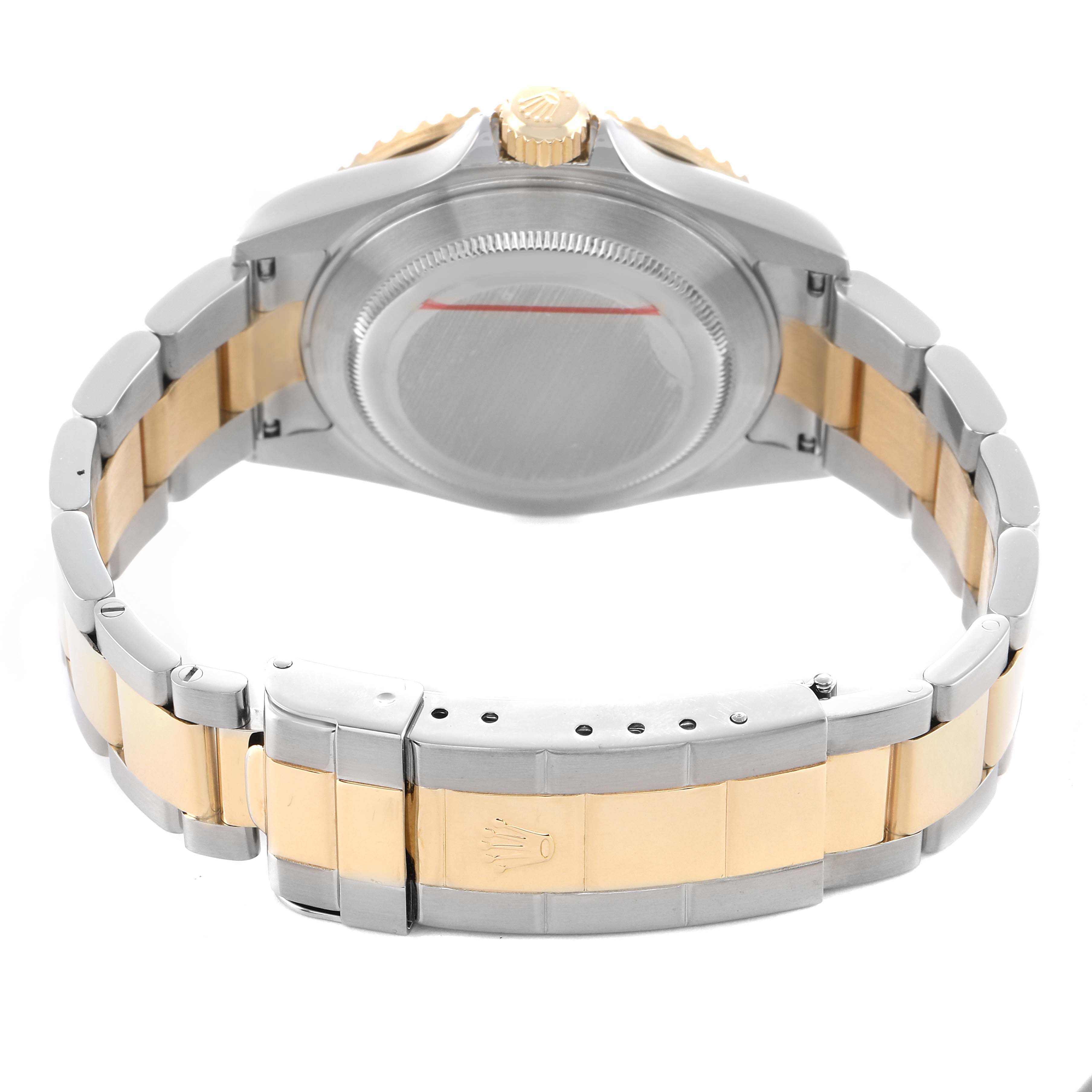 The image shows the back case and bracelet of a Rolex Submariner 16613 Men's Steel and Gold (two tone) Black Dial, highlighting its two-tone metal finish and clasp.