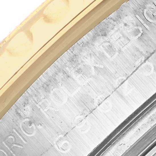 The image shows a close-up of the case side and bezel edge of a Rolex Yacht-Master 69623 Women
s Steel and Gold (two tone) White Dial 69623 Women
s Steel and Gold (two tone) White Dial watch.