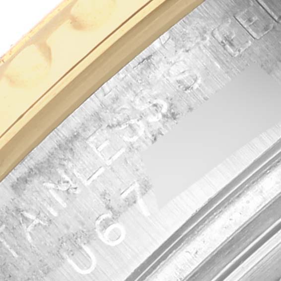 The image shows a close-up of the Rolex Yacht-Master 69623 Women
s Steel and Gold (two tone) White Dial 69623 Women
s Steel and Gold (two tone) White Dial model
s bezel and case edge, highlighting part of the metal engraving.