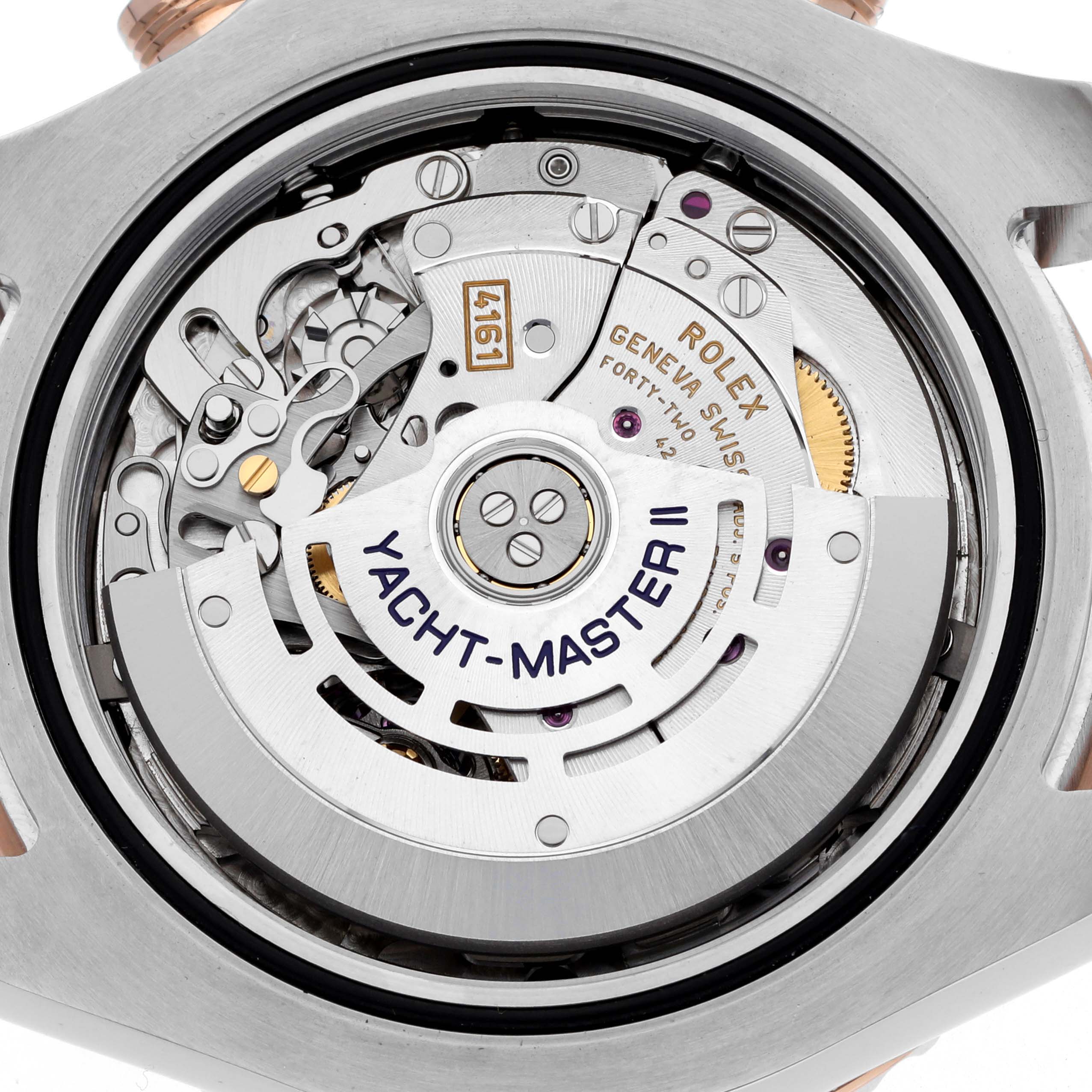 The image shows the back view of a Rolex Yacht-Master 116681M Men's Steel and Gold (two tone) White Dial II, displaying its intricate movement and rotor.