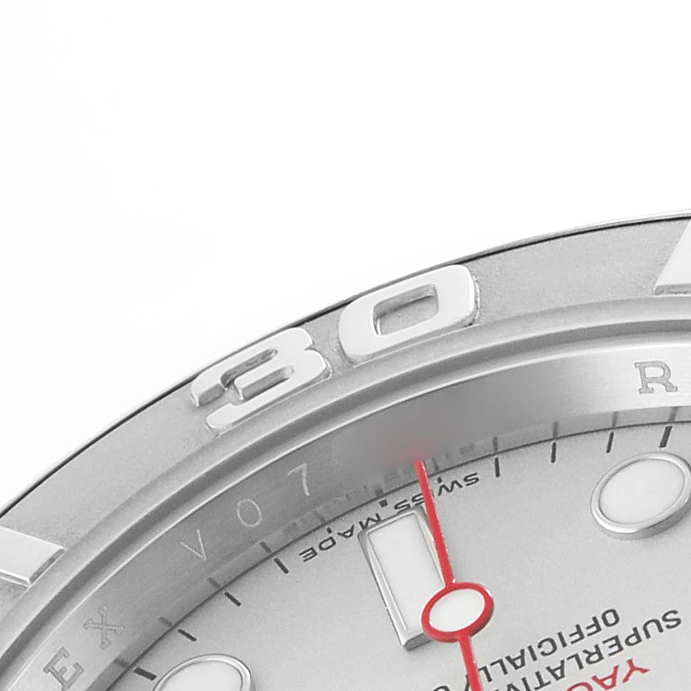 The image shows a close-up of the Rolex Yacht-Master 16622 Men's Stainless Steel Grey Dial's bezel and part of the dial, featuring hour markers and a red second hand.
